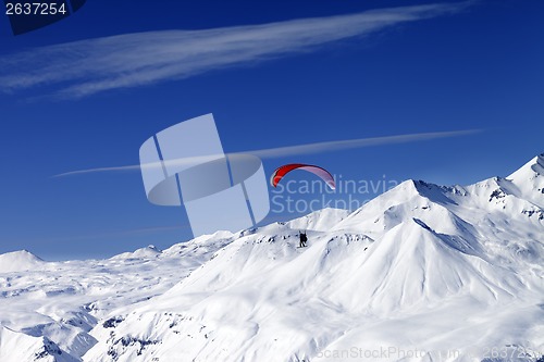 Image of Sky gliding in snowy mountains at nice sun day