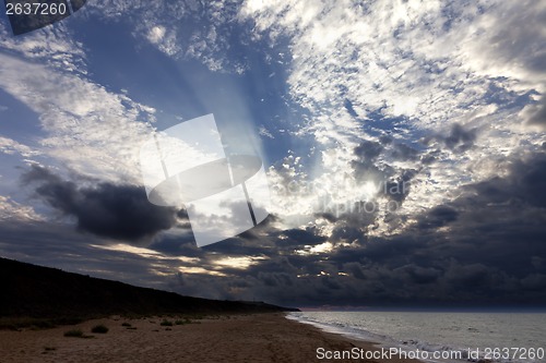 Image of Sea beach in evening and sunlight clouds