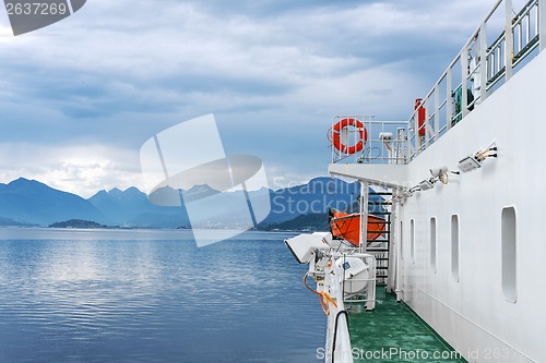 Image of Ferry ship sailing in still water of a fjord