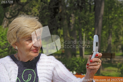 Image of Senior woman with camera phone