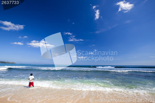 Image of A local fishing in a tropical beach