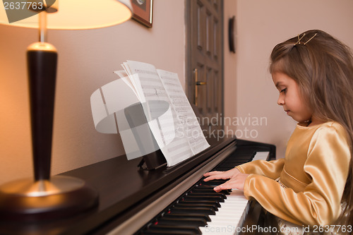 Image of Little girl playing the piano