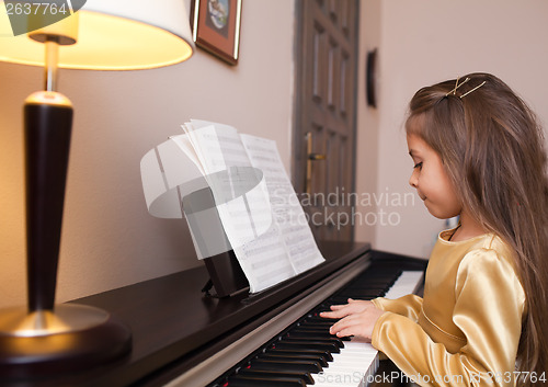 Image of Little girl playing the piano