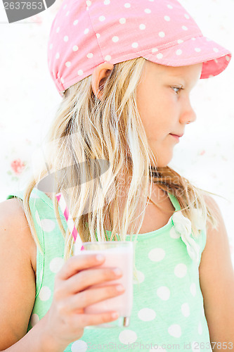 Image of Young girl holding smoothie drink