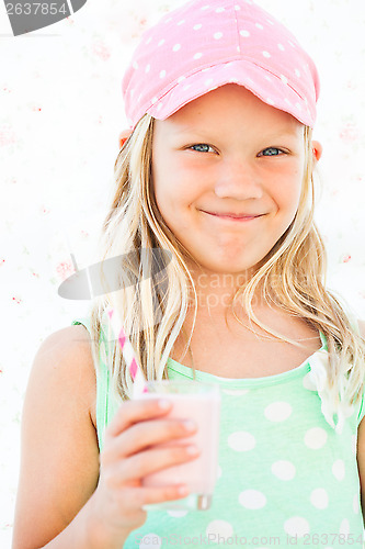 Image of Smiling young girl holding smoothie drink