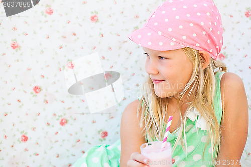 Image of Smiling young girl holding smoothie drink