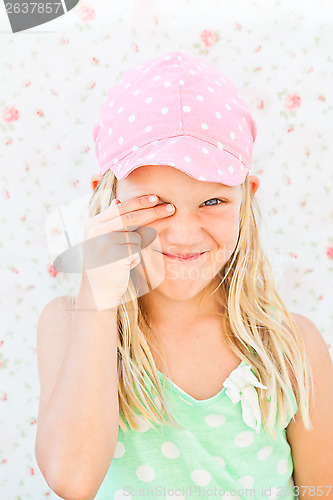 Image of Cute happy girl covering eye