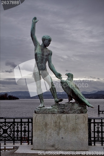 Image of  man and a eagle near the lake