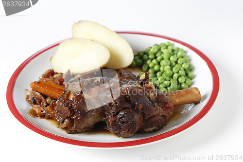 Image of Braised lamb shanks with potatoes and peas