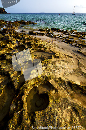 Image of rock beach  water boat  and summer in lanzarote spain