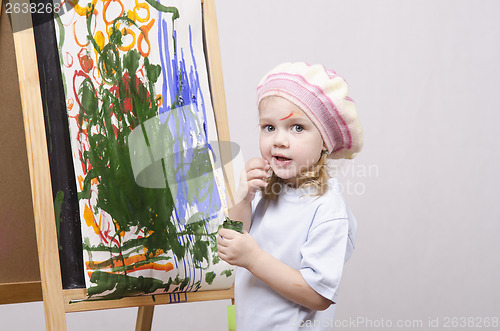 Image of Girl artist paints on canvas