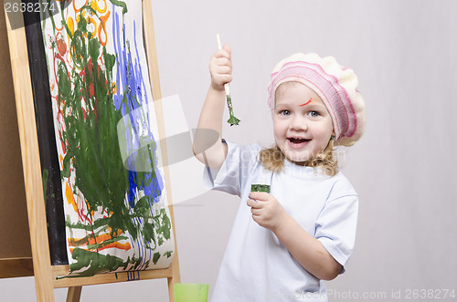 Image of Girl artist paints on canvas