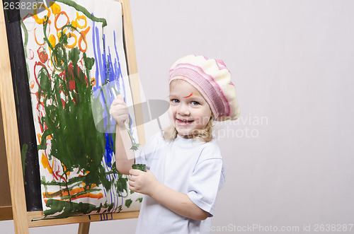 Image of Girl artist paints on canvas