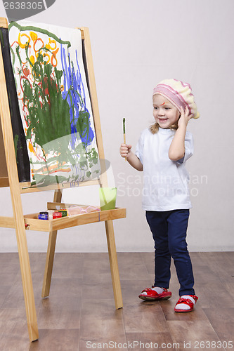 Image of Girl artist paints on canvas