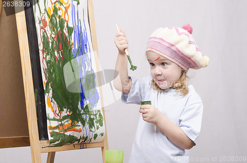 Image of Girl artist paints on canvas