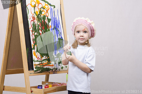 Image of Girl artist paints on canvas