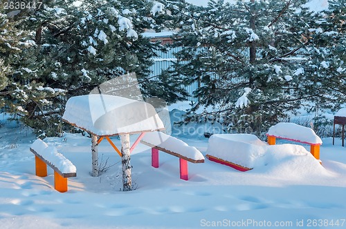 Image of benches with table in the snow