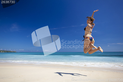 Image of Woman jumping on the beach