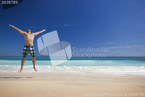 Image of Man jumping on the beach