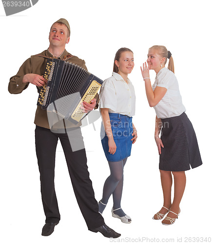 Image of Two girls and a guy with an accordion 