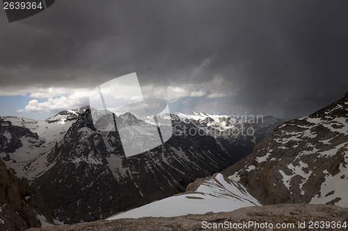 Image of Snowy mountains and storm clouds