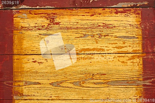 Image of Yellow wooden shield with red frame