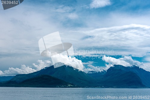 Image of Fjord scene with hazy mountains and  cloudy sky