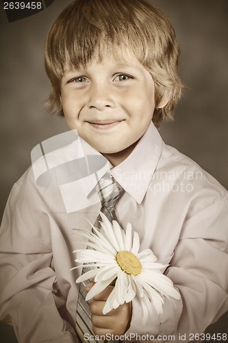 Image of boy wearing classic suit with flowers