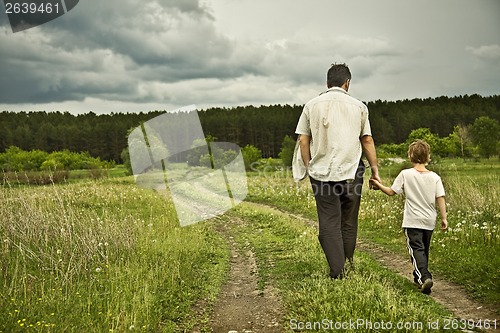 Image of boy and his father are on the road