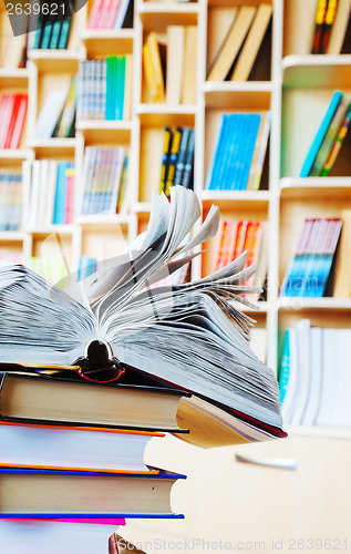 Image of Open book on a stack of books