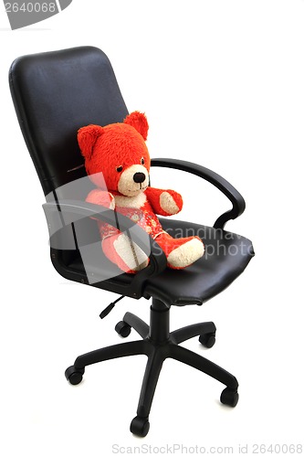 Image of red bear toy in the office chair