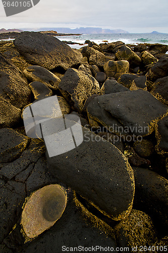 Image of rock stone sky cloud beach  coastline and summer in lanzarote sp