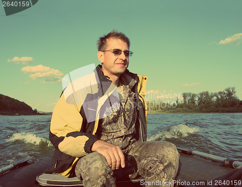 Image of fishing men on boat with motor - vintage retro style