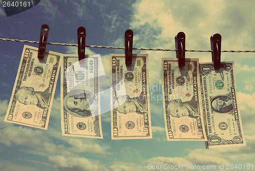 Image of paper dollars are drying on rope - vintage retro style
