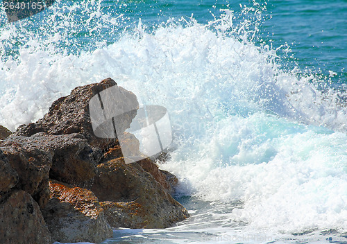 Image of sea waves breaking on rocks