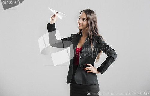 Image of Woman throwing a paper plane