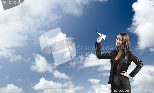 Image of Business woman throwing a paper plane