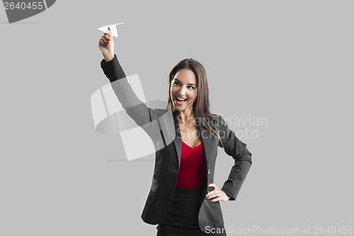 Image of Woman throwing a paper plane