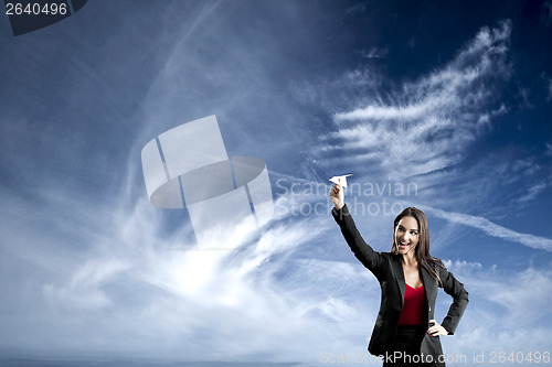 Image of Business woman throwing a paper plane