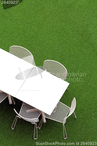 Image of Chair and table on lawn at outdoor