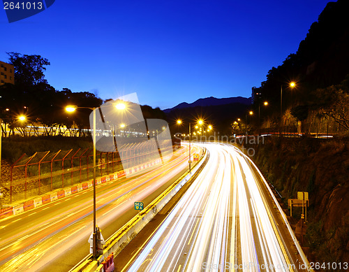 Image of Traffic trail on highway during sunset