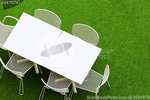 Image of Outdoor chair and table on lawn