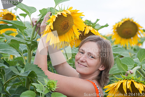 Image of smiling woman with sunflower