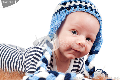Image of Newborn baby in striped body and hat