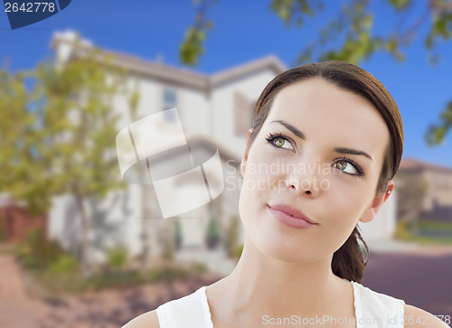 Image of Thoughtful Mixed Race Woman In Front of House