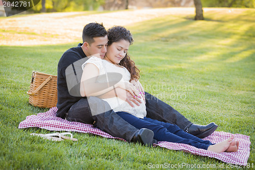 Image of Pregnant Hispanic Couple in The Park Outdoors