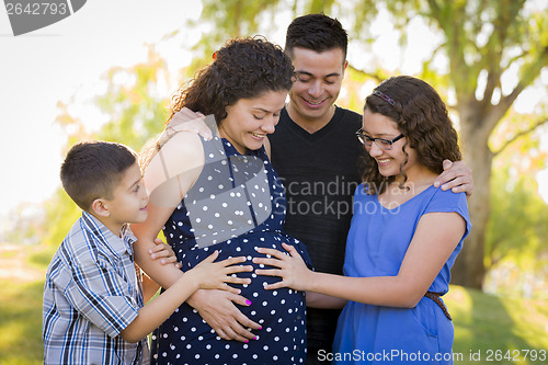 Image of Hispanic Family Hands on Pregnant Mother Tummy Feeling Baby Kick