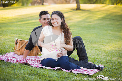 Image of Pregnant Hispanic Couple in The Park Outdoors