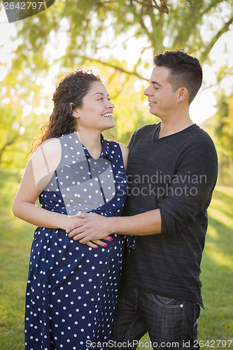 Image of Hispanic Man With His Pregnant Wife Outdoors At the Park