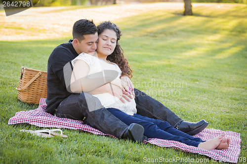 Image of Pregnant Hispanic Couple in The Park Outdoors